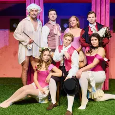 Aktorzy w strojach z epoki na scenie Teatru Capitol, przygotowujący się do sylwestrowego spektaklu.